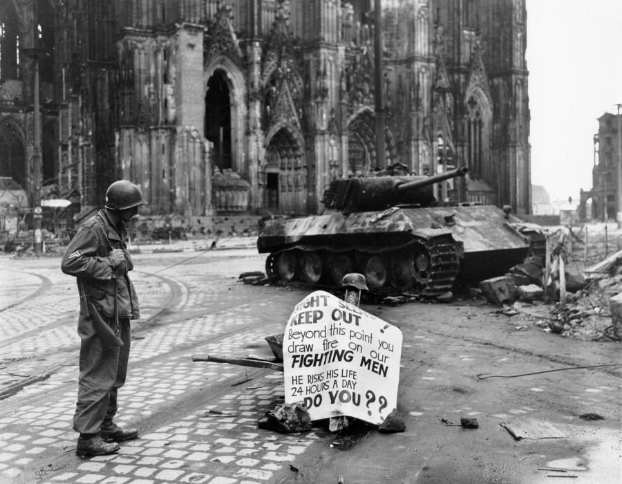 Cpl. Luther E. Boger, Concord, N.C., skytrooper, reads a warning sign in the street