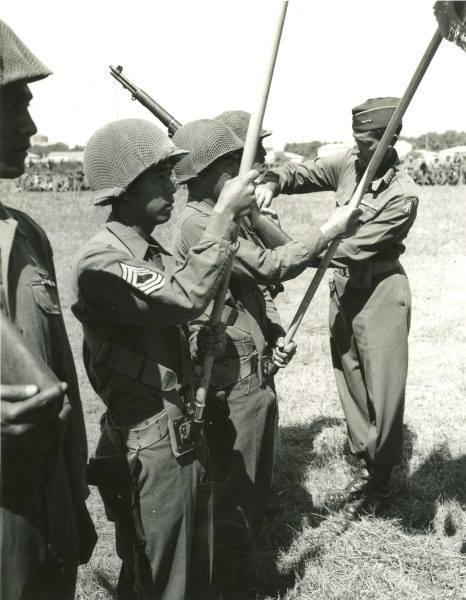 Lt. Gen. Mark W. Clark, C.G. of the 5th Army, pinning ribbon awards